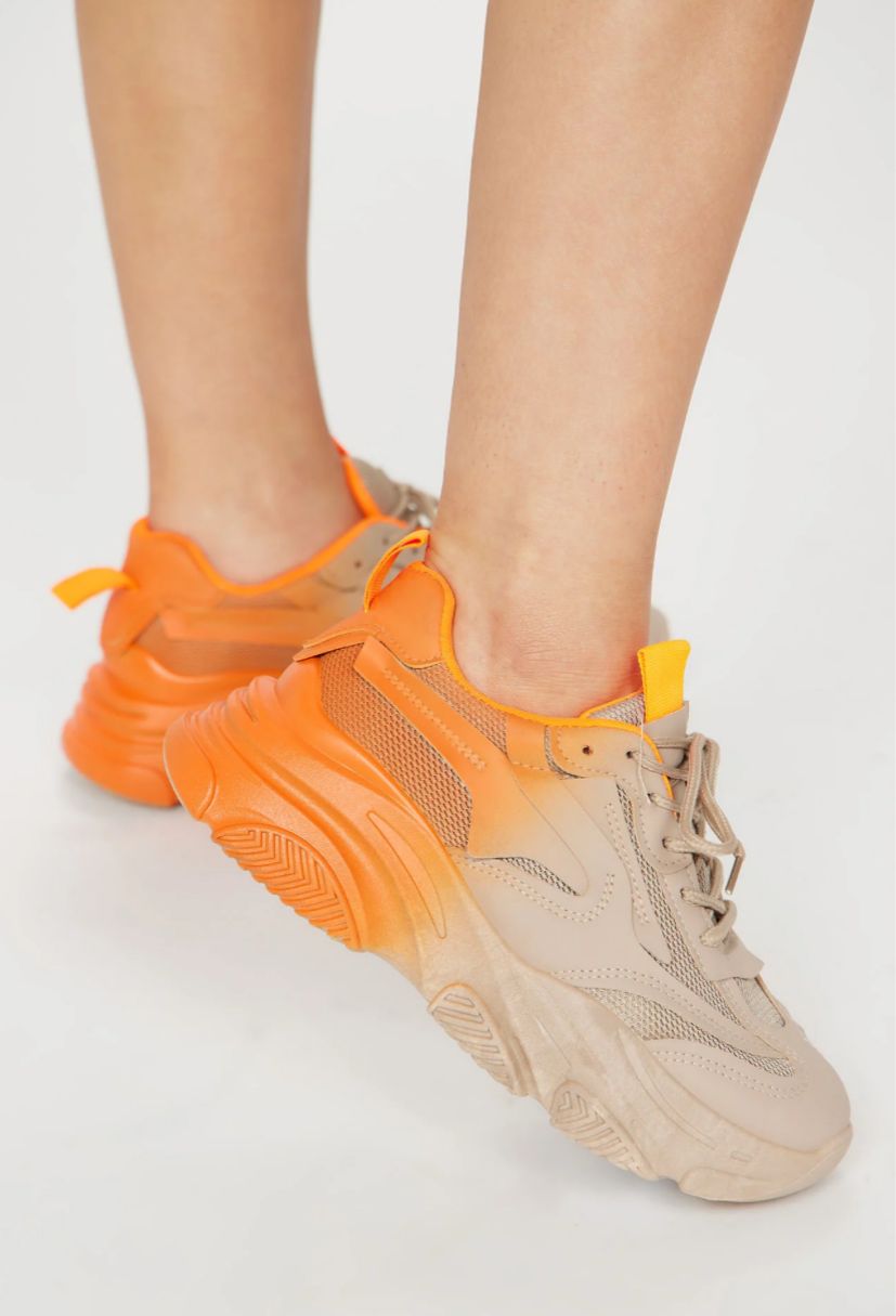 Beige and orange sneakers on a light gray background